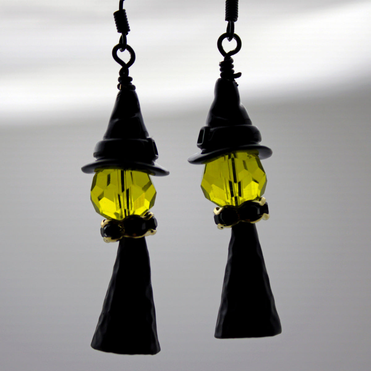 Witch with a black witch hat and gold accents