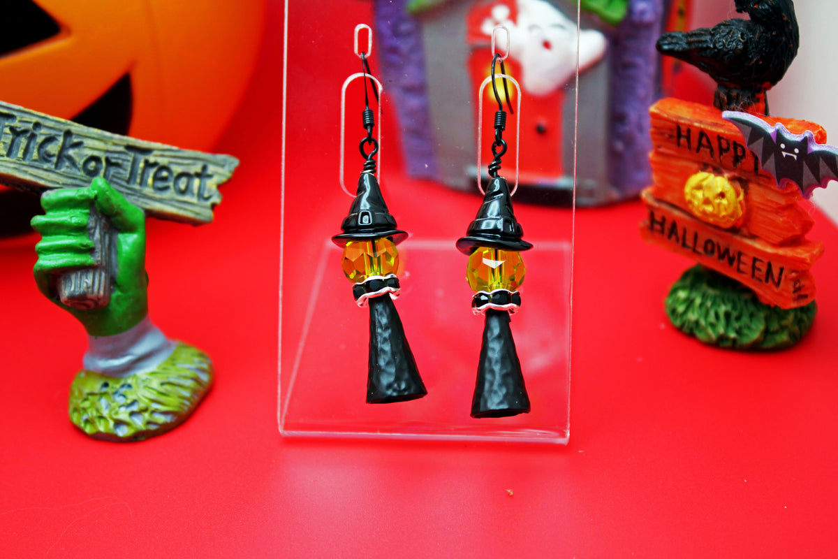 Witch with a black witch hat and silver accents